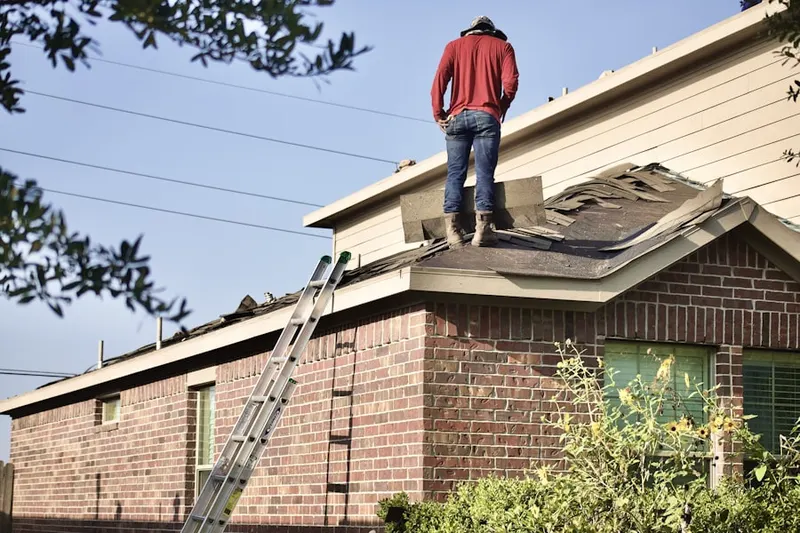 Professional roofer working on a residential roof in Peoples Park